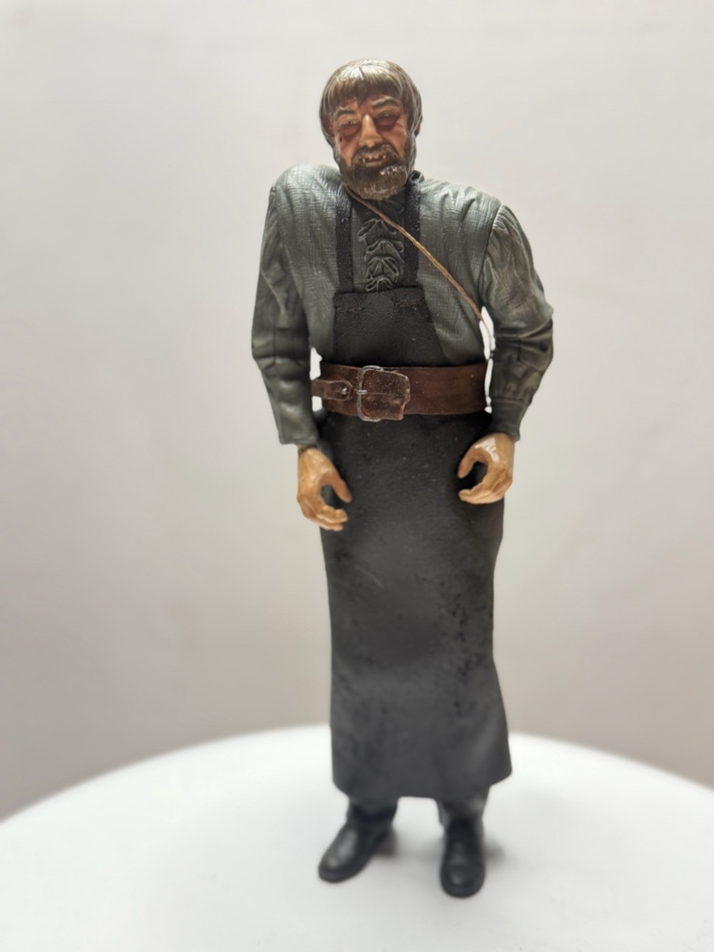 Hand-Painted Male Figurine in Black Apron and Green Shirt